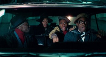 Movie still from “Cooley High” (1975), directed by Michael Schultz – A group of people in a car looking out the window; Medium shot, Low angle