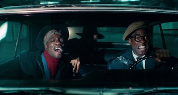 Movie still from “Cooley High” (1975), directed by Michael Schultz – Two men sitting in the back seat of a car; Medium shot, Low angle