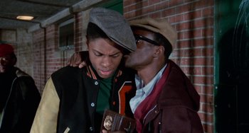 Movie still from “Cooley High” (1975), directed by Michael Schultz – A man kissing another man on the cheek; Close Up shot, Over the shoulder angle