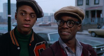 Movie still from “Cooley High” (1975), directed by Michael Schultz – A couple of men standing next to each other on a street; Close Up shot, Over the shoulder angle