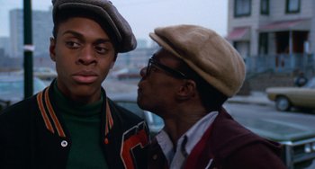 Movie still from “Cooley High” (1975), directed by Michael Schultz – Two young men standing next to each other on the street; Close Up shot, Over the shoulder angle