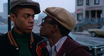 Movie still from “Cooley High” (1975), directed by Michael Schultz – Two young men standing next to each other on a city street; Close Up shot, Over the shoulder angle