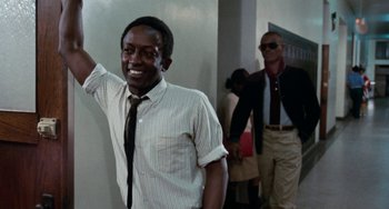 Movie still from “Cooley High” (1975), directed by Michael Schultz – A man wearing a tie and a striped dress shirt; Medium shot, Low angle