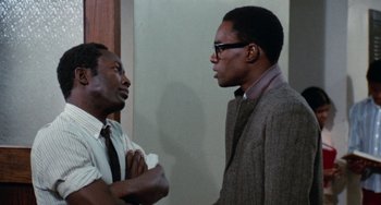 Movie still from “Cooley High” (1975), directed by Michael Schultz – Two men talking to each other in front of a wall; Medium shot, Over the shoulder angle