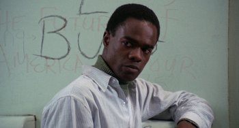 Movie still from “Cooley High” (1975), directed by Michael Schultz – A young man in front of a white wall with writing on the wall; Close Up shot, Low angle