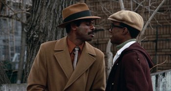 Movie still from “Cooley High” (1975), directed by Michael Schultz – A couple of men standing next to each other on a street; Close Up shot, Over the shoulder angle