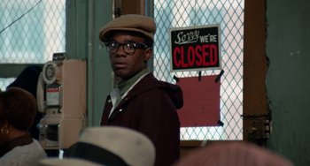 Movie still from “Cooley High” (1975), directed by Michael Schultz – A man standing in front of a closed sign; Close Up shot, Over the shoulder angle