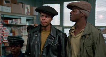 Movie still from “Cooley High” (1975), directed by Michael Schultz – A couple of men standing next to each other; Close Up shot, Over the shoulder angle