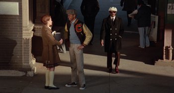 Movie still from “Cooley High” (1975), directed by Michael Schultz – Two men and a woman standing on a sidewalk; Wide shot, Over the shoulder angle
