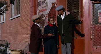 Movie still from “Cooley High” (1975), directed by Michael Schultz – A group of people standing next to each other on a sidewalk; Wide shot, Low angle