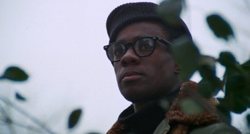 Movie still from “Cooley High” (1975), directed by Michael Schultz – A person wearing glasses and a hat; Close Up shot, Low angle
