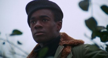 Movie still from “Cooley High” (1975), directed by Michael Schultz – A person wearing a hat and a jacket; Close Up shot, Low angle
