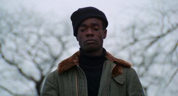 Movie still from “Cooley High” (1975), directed by Michael Schultz – A man wearing a black hat and a green jacket; Close Up shot, Low angle