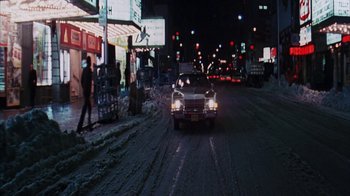 Movie still from “Coonskin” (1974), directed by Ralph Bakshi – A car driving down a street at night; Extreme Wide shot, High angle