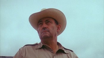 Movie still from “Coonskin” (1974), directed by Ralph Bakshi – A man wearing a cowboy hat looking up at the sky; Close Up shot, Low angle
