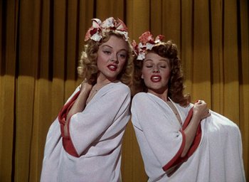 Movie still from “Cover Girl” (1944), directed by Charles Vidor – A couple of women standing next to each other; Medium shot, Overhead angle
