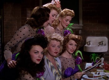 Movie still from “Cover Girl” (1944), directed by Charles Vidor – A group of women standing next to each other in front of a sink; Medium shot, Low angle