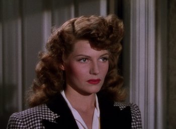 Movie still from “Cover Girl” (1944), directed by Charles Vidor – A person wearing a suit and tie; Close Up shot, High angle