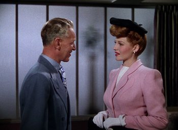 Movie still from “Cover Girl” (1944), directed by Charles Vidor – A man and a woman talking to each other; Medium shot, Low angle