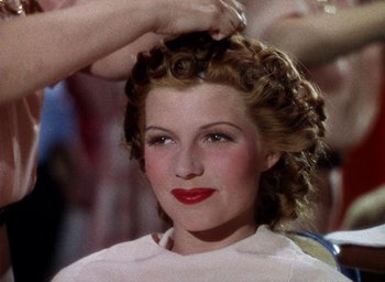 Movie still from “Cover Girl” (1944), directed by Charles Vidor – A person getting her hair done; Close Up shot, Low angle