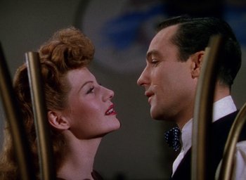 Movie still from “Cover Girl” (1944), directed by Charles Vidor – A man and a woman face to face in front of each other; Close Up shot, Overhead angle