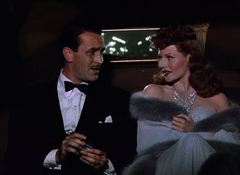 Movie still from “Cover Girl” (1944), directed by Charles Vidor – A man and a woman in formal wear talking to each other; Medium shot, Low angle