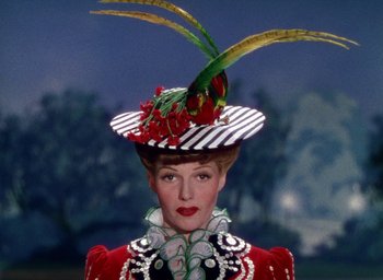 Movie still from “Cover Girl” (1944), directed by Charles Vidor – A woman wearing a hat with a bird on top of her head; Close Up shot, Low angle
