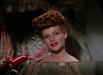 Movie still from “Cover Girl” (1944), directed by Charles Vidor – A person holding a brush in a mirror; Close Up shot, Low angle