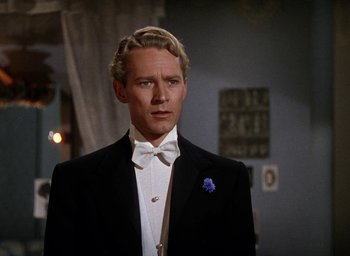Movie still from “Cover Girl” (1944), directed by Charles Vidor – A man wearing a tuxedo and a bow tie; Close Up shot, Over the shoulder angle