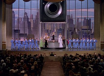 Movie still from “Cover Girl” (1944), directed by Charles Vidor – A large crowd of people are watching a performance; Extreme Wide shot, Low angle