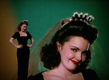 Movie still from “Cover Girl” (1944), directed by Charles Vidor – A woman standing next to a woman in a black dress; Medium shot, Low angle