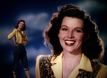 Movie still from “Cover Girl” (1944), directed by Charles Vidor – A woman in a yellow shirt and a woman in a yellow shirt; Medium shot, Low angle