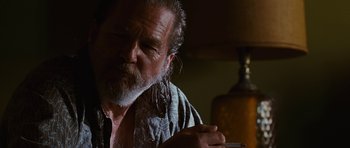 Movie still from “Crazy Heart” (2009), directed by Scott Cooper – An older man smoking a cigarette in a dark room; Close Up shot, Low angle