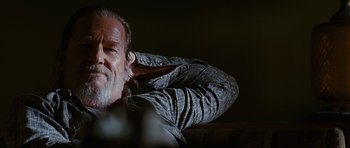 Movie still from “Crazy Heart” (2009), directed by Scott Cooper – An older man leaning back on a chair; Close Up shot, Over the shoulder angle