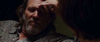 Movie still from “Crazy Heart” (2009), directed by Scott Cooper – A person holding his hand to his forehead; Close Up shot, Over the shoulder angle