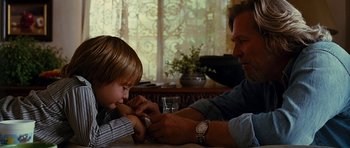 Movie still from “Crazy Heart” (2009), directed by Scott Cooper – A man and a boy sitting at a dining table; Close Up shot, Over the shoulder angle