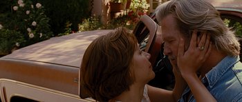 Movie still from “Crazy Heart” (2009), directed by Scott Cooper – A man and a woman in front of an old car; Close Up shot, Low angle