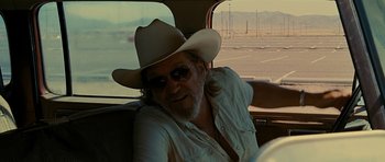 Movie still from “Crazy Heart” (2009), directed by Scott Cooper – A man in a cowboy hat sitting in the back of a car; Close Up shot, Over the shoulder angle