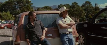 Movie still from “Crazy Heart” (2009), directed by Scott Cooper – Two men sitting next to each other on the back of a truck; Medium shot, Low angle