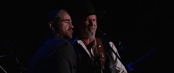 Movie still from “Crazy Heart” (2009), directed by Scott Cooper – Two men in cowboy hats are standing next to each other; Close Up shot, Over the shoulder angle