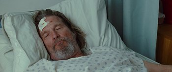 Movie still from “Crazy Heart” (2009), directed by Scott Cooper – A person laying in a hospital bed; Close Up shot, Low angle