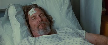 Movie still from “Crazy Heart” (2009), directed by Scott Cooper – A person laying in a hospital bed; Close Up shot, Overhead angle