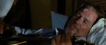 Movie still from “Crazy Heart” (2009), directed by Scott Cooper – A person sitting at a table; Close Up shot, High angle