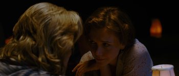 Movie still from “Crazy Heart” (2009), directed by Scott Cooper – A woman sitting next to another woman in a dark room; Close Up shot, Over the shoulder angle