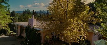 Movie still from “Crazy Heart” (2009), directed by Scott Cooper – A house with a tree in front of it and mountains in the background; Extreme Wide shot, Low angle