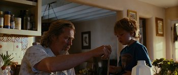 Movie still from “Crazy Heart” (2009), directed by Scott Cooper – A man and a boy are playing with a toy; Medium shot, Low angle