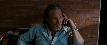 Movie still from “Crazy Heart” (2009), directed by Scott Cooper – An older man with a beard is talking on a cell phone; Close Up shot, Low angle