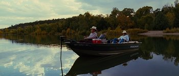 Movie still from “Crazy Heart” (2009), directed by Scott Cooper – Two men in a boat on a river; Wide shot, High angle