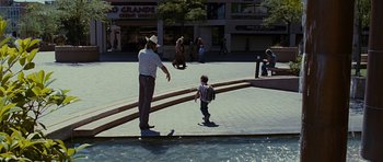 Movie still from “Crazy Heart” (2009), directed by Scott Cooper – A man riding a skateboard down the side of a river; Wide shot, High angle