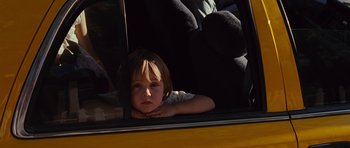 Movie still from “Crazy Heart” (2009), directed by Scott Cooper – A little girl sitting in the back seat of a car; Close Up shot, Over the shoulder angle